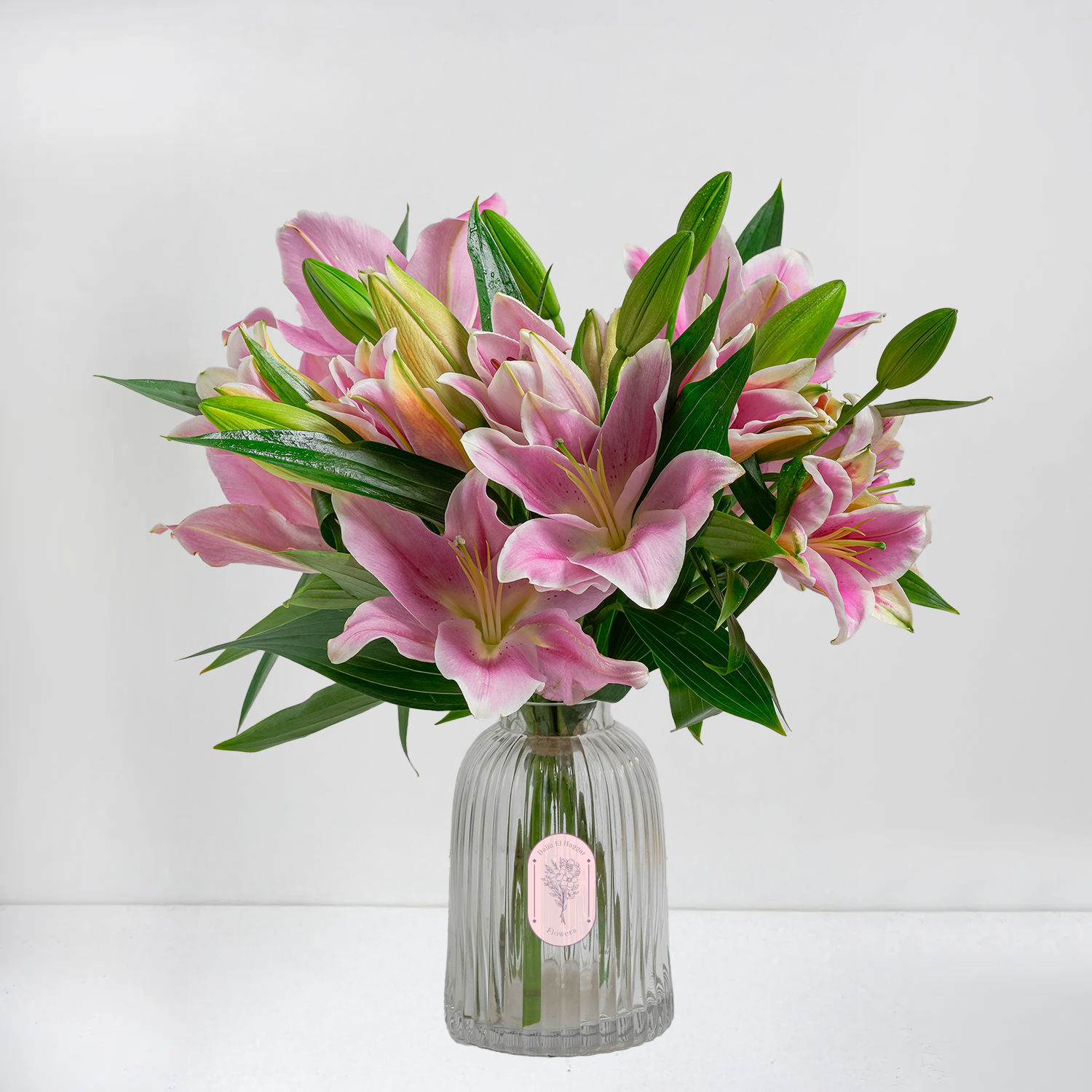 Pink Lilies & Lush Greens in Refreshing Glass Vase