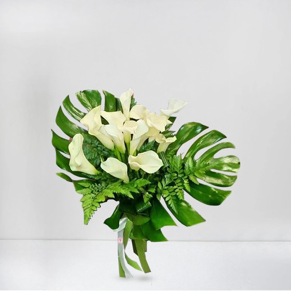 white calla with bold tropical leaves